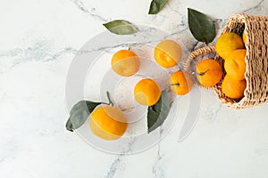 Orange juicy tangerine slices and peeled mandarines scattered on the white marble background. Flat lay. Copy space. Fresh summer