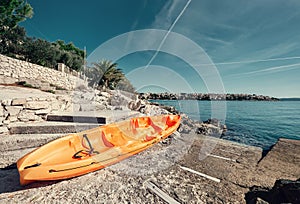 Orange kayak is on the sea pier, Adriatic seaside od Croatia