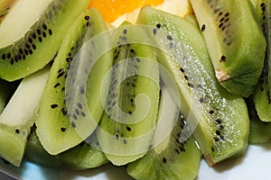 Orange and kiwi slices isolated on a white background