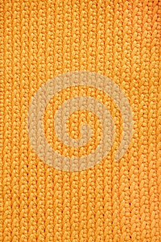 Orange knitted fabric texture background. Top view. Copy, empty space for text