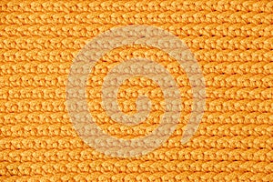 Orange knitted fabric texture background. Top view. Copy, empty space for text