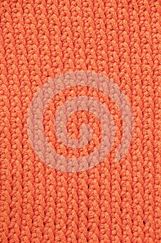 Orange knitted fabric texture background. Top view. Copy, empty space for text