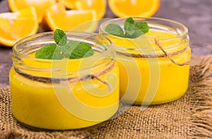 Orange Kurd in low jars. Orange summer, refreshing dessert. Close-up. photo