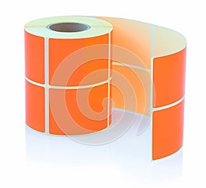 Orange label roll isolated on white background with shadow reflection. Color reel of labels for printers.