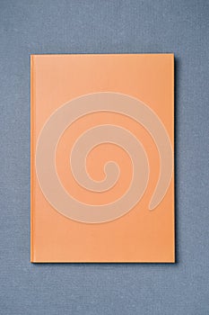 Orange leather notebook on a gray background