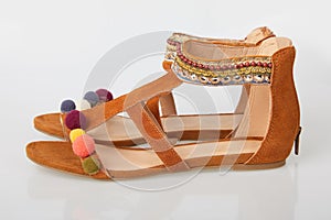 Orange leather strappy sandal toe straps isolated photo