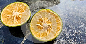 Orange lemon background.Double slice of lemon selective focus on texture background with copy space