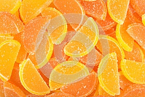 Orange and lemon candy slices as background