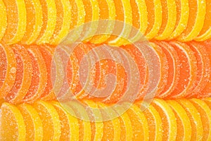 Orange and lemon candy slices as background