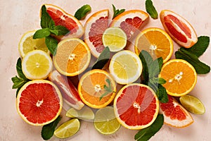 Orange, lemon, grapefruit, mandarin and lime on trendy pink stone or concrete table background. Citrus fruits. Top view, flat lay