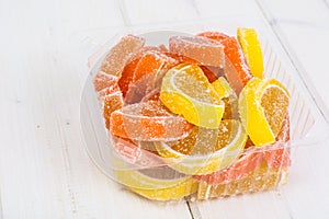 Orange and lemon jelly slices on white background