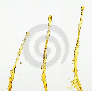 Orange, lemon juice or oil lubricant splash, liquid gold yellow drink drops. Fruit beverage water elements in line form . Fresh