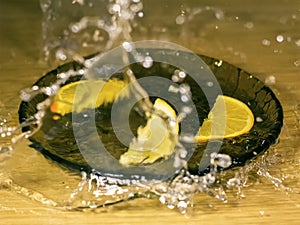 Orange and lemon on a wooden with waterdrops