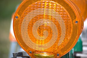 The orange lens of a construction barricade light contains some interesting patterns.