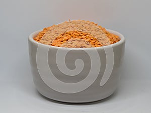 Orange lentils in the grey cup