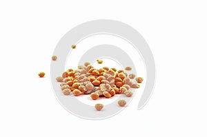 Orange lentils that are quick to cook on a white background. the lists are often used in Indian cuisine