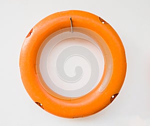 Orange life buoy hanging on the wall.