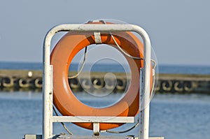 Orange life buoy ring life belt in port