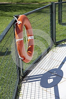 Orange life guard ring at the swimming pool.