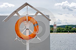 Orange lifebuoy at the beach, lifeguard float. lifeguard equipment, life saver or life ring. Concept of vacation and safety when
