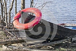 Orange lifebuoy and old rope on the boat
