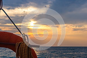 orange lifebuoy on a pebbly sea beach