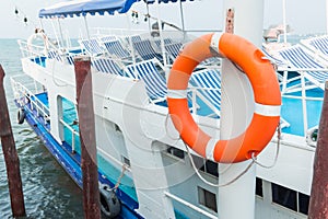 Orange lifebuoy, safety equipment, at the pier