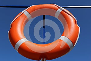 Orange lifebuoy on a ship board