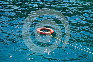 Orange lifebuoys float on the sea