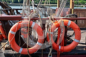 orange lifebuoys on old sailboat