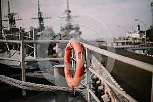 Orange lifebuoys placed on a ship,