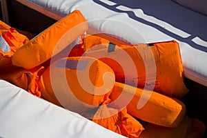 Orange lifejackets for tourists in a pleasure boat. safety precautions at sea