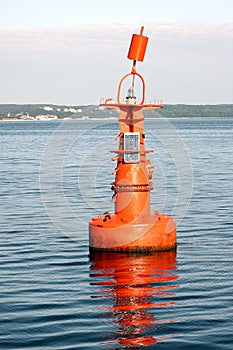 Orange light buoy in ocean