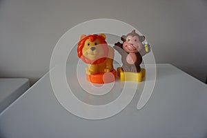 Orange lion and brown monkey plastic toys