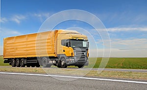 Orange lorry with trailer