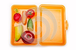 Orange lunch box with fuit and vegetables