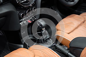 Orange luxury car Interior with steering wheel, shift lever and