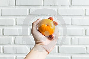 orange in man's hand