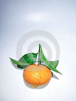 the orange mandarin as we know santang orange or shantang isolated on white, fresh and sweet mandarin orange with leaves,