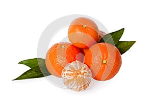 Orange mandarines, clementines, tangerines or small oranges with one peeled with leaves