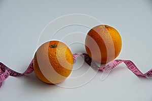 Orange with measuring tape. White background. Comceptual