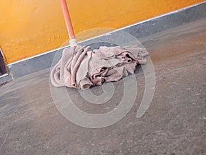 An orange microfiber strip mop