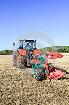 Kubota M7-173 ploughing on stubble in crop field