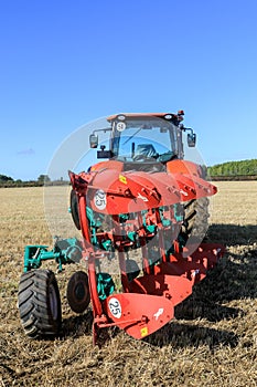 Kubota M7-173 ploughing on stubble in crop field