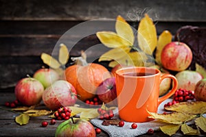 Orange mug on autumn background photo