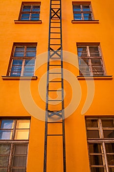 Orange multi storey with fire escape leading