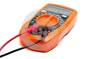 Orange multimeter on a white