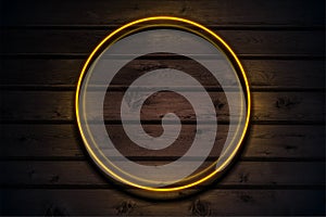 Orange neon luminous circle frame on dark brown wooden abstract background