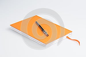 Orange note book and pen
