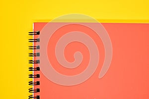orange notebook on yellow background, stationery for office